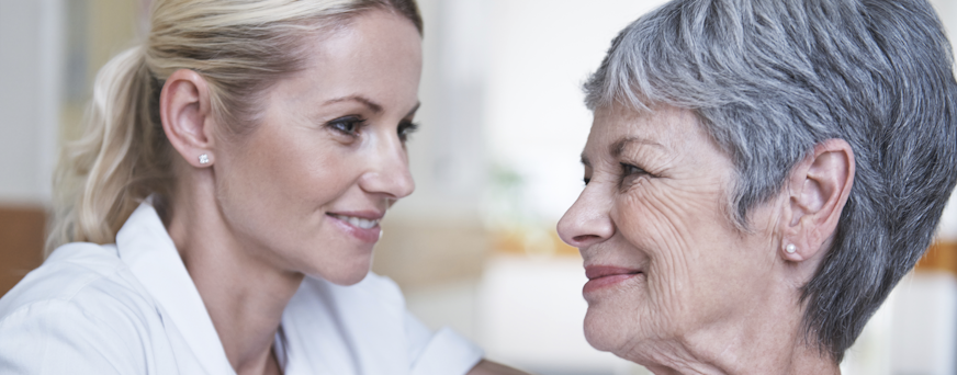 Life Assure Senior Woman Speaking With Caregiver Hero